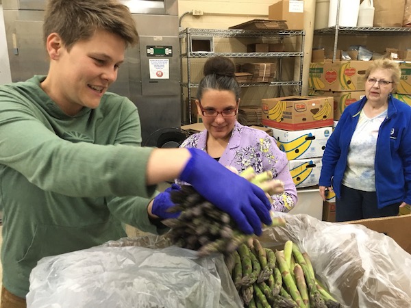 Groundwork Christina Barkel at left packages food at Food Rescue warehouse