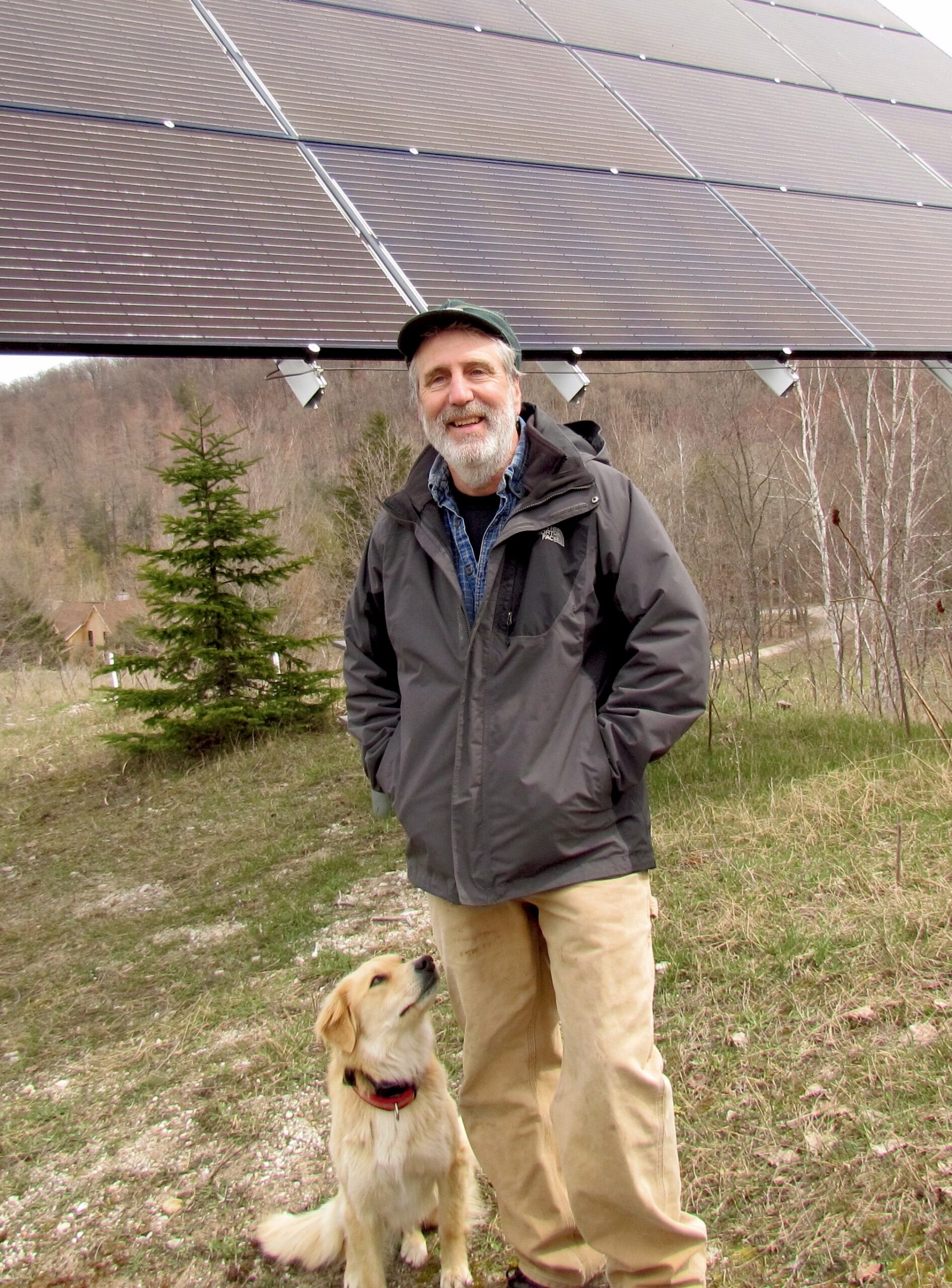 Jim Lively with dog and solar panel