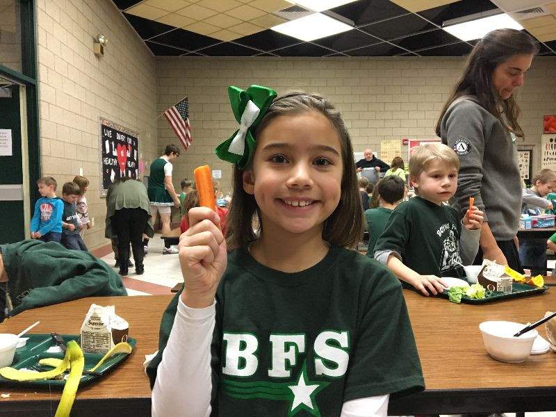 Boyne Falls student with carrot